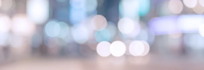 A blurred cityscape background featuring colorful bokeh lights, creating a dreamy urban atmosphere suitable for various design projects. © al-sultan