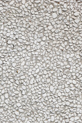 pebbledash roughcast wall background with white pebbles set in cement © Axel Bueckert