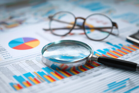 Analyzing and gathering statistical data. Growth charts. Many business reports and magnifying glass