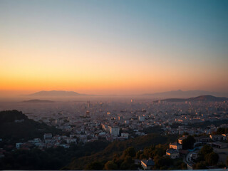 Fototapeta premium Sunset panoramic view from Lycabettus Hill overlooking city soft orange sky fading into blue smooth gradient large open sky