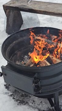 Firewoods burning in a fireplace. Hot flames in the bonfire or camfire. Video, motion and animation.