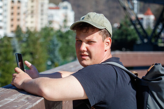Person using smartphone near railing