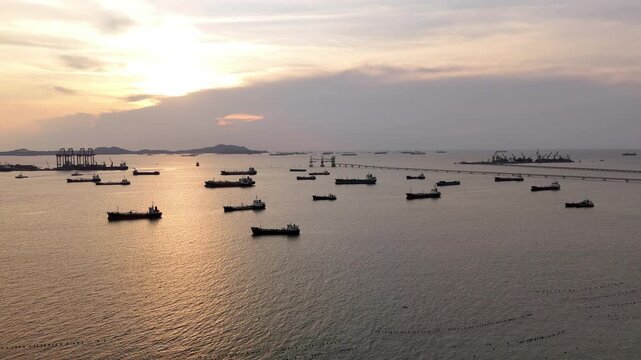 fast patrol boat with LPG gas and oil tanker ships anchored in the ocean, with a fast patrol boat in the foreground. Global energy transport, war energy crisis, and Strait of Hormuz blockade concept.	