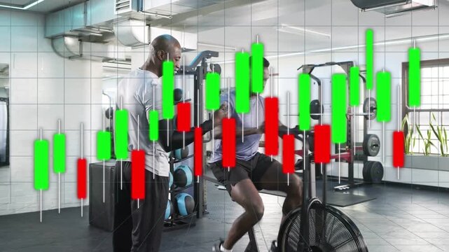 Trainer walking up to trainee riding fan bike, coaching form for fitness while overlay tracking rpm
