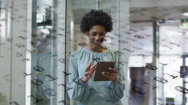 Office woman holding tablet behind glass with numeric overlay, tapping and revealing finance charts