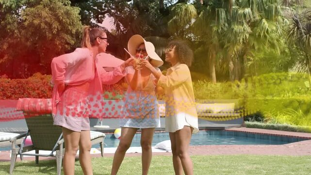 3 women raising drinks, toasting poolside for lifestyle ad while redyellow wave sweeping over group