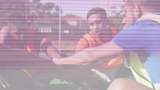 Male players reaching in stacking hands, raising arms for sports warmup under pink scanline overlay