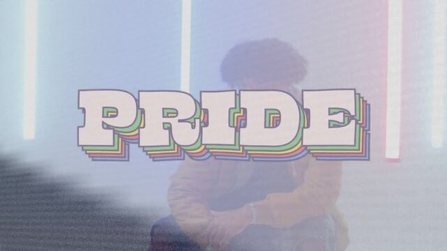 Adult male sitting, shifting and turning head while diagonal band sweeping, powering PRIDE branding