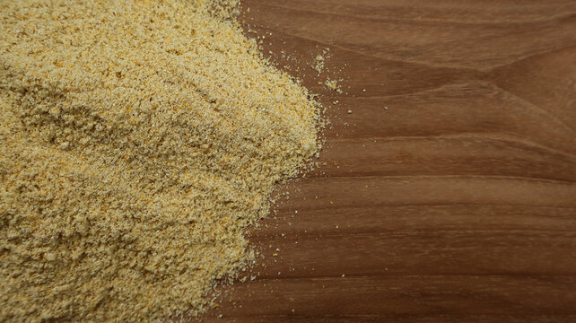 Top View Closeup of Corn Flour on Wooden Surface with Copy Space