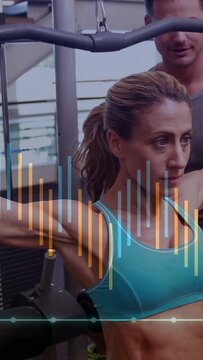 Vertical video: Coach spotting while woman doing chest fly, HUD overlay tracking strength metrics