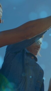 Vertical video: Center in denim lifting arm, causing animated bottle popping, group toasting ads