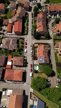 Aerial View of a Quaint Suburban Street: An elevated perspective unveils a charming street lined with homes, offering a bird's-eye view of community life.