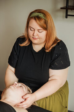 Therapist performing scalp massage on client