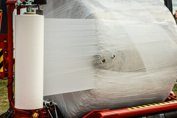 Bale of hay wrapped in plastic foil © Voyagerix