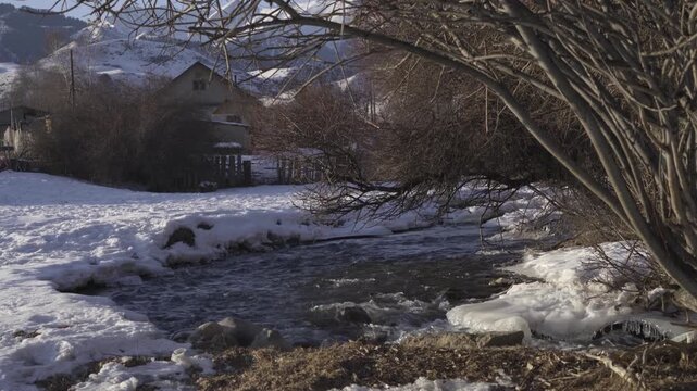 Calm Snowy River with Village Homes in Saty Village, Kazakhstan &ndash; 4K