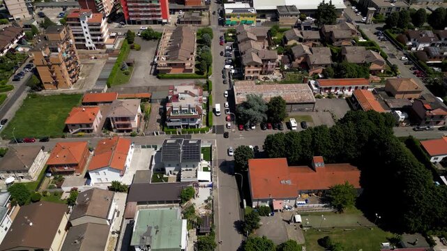 Urban Landscape Aerial View: An encompassing shot capturing a vibrant cityscape from a bird's-eye perspective, showcasing orderly rows of buildings, trees, and roads. A bustling urban sprawl.