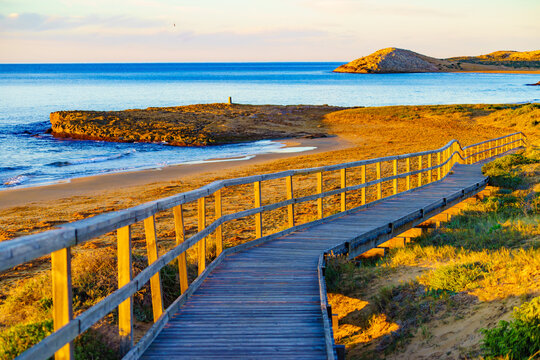 Beach with wooden path to sea water.