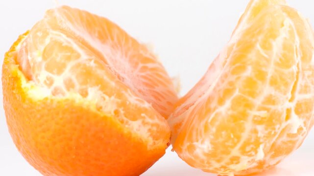 Slices of yellow ripe tangerine isolated on the white background
