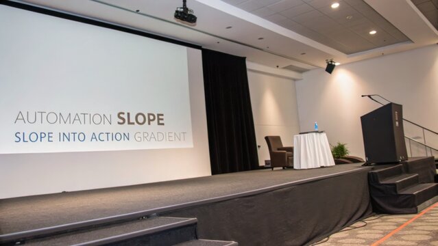 Empty Presentation Stage with Projector Screen and Speaker Setup in a Conference Room