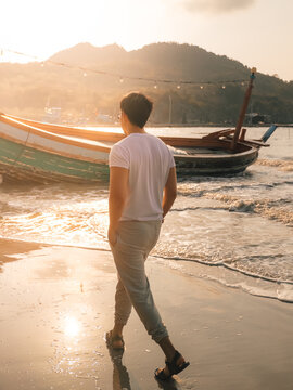 Serene coastal town with reflective water and vibrant boat nearby