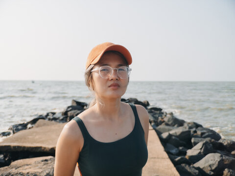 Asian woman environmental researcher standing on jetty