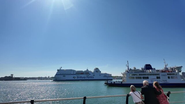 Portsmouth England UK. 28.04.2026. Video. Visitors watch a cross channel ferry depart Portsmouth Harbour for France passing an Isle of Wight roro ferry on moorings.
