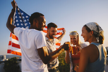Friends celebrating 4th of july with beers and american flag
