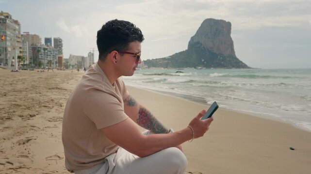 Remote Work Conflict: Stressed Businessman Having Intense Video Call Arguing on Beach Pointing to Ocean Representing Executive Burnout and Always-On Culture