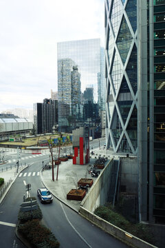 Paris, France - March 9, 2026. A high-angle vertical shot showcasing the striking contemporary architecture of La D&eacute;fense in Paris. The image features the iconic D2 Tower with its distinctive external