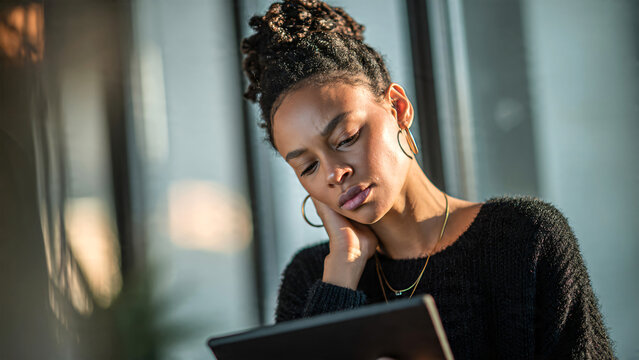 Woman using tablet with neck pain at home, fatigue and poor posture from remote work, minimal interior, soft lighting, high resolution, stress and wellness concept.