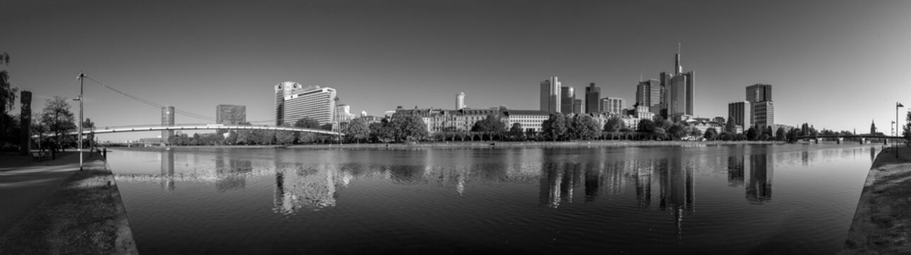 panoramic view to skyline of Frankfurt with mirroring in river Main, Germany