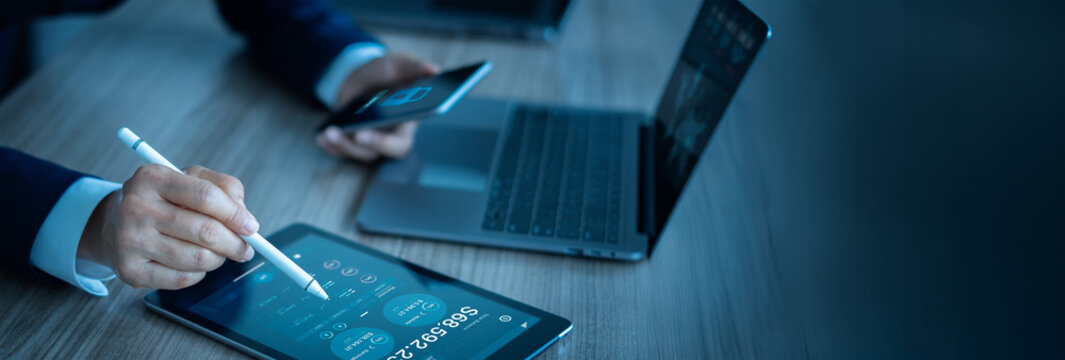 
Businessman analyze and calculate data finances online while protecting data security on financial and banking networks with digital Smart solution from cyber attack, online banking and payments.