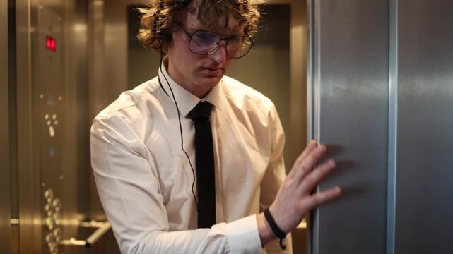 Office worker steps out of the elevator in formal clothes with calm focus and a composed mood capturing business routine office movement and the start of a workday