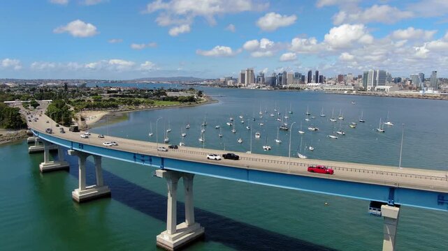 Aerial Drone Reveal Of San Diego Skyline And Sailboats From Coronado Bridge