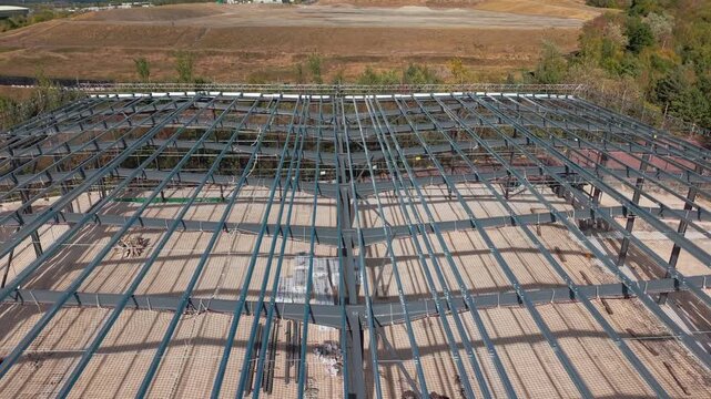 Construction of new building frame in rural area during autumn season with clear skies and ongoing work