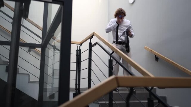Shocked office worker reacts to unexpected results walking on stairwell covering mouth with hand feeling surprise stress and disbelief in modern workplace environment