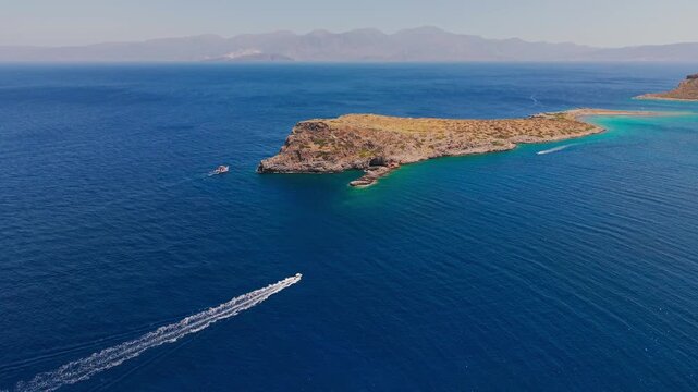 High angle view of motorboats leaving white wakes in deep blue Mediterranean water