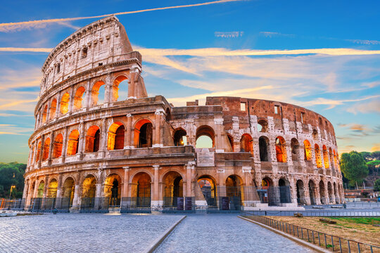 Colosseum at sunset with dramatic colorful sky in Rome, Italy