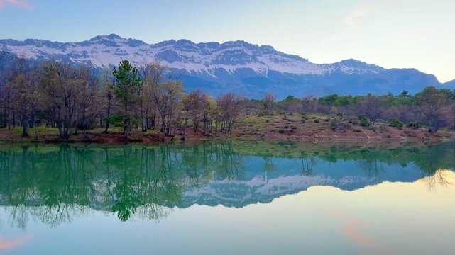 Stunning mirror reflection of alpine mountains on a calm water surface