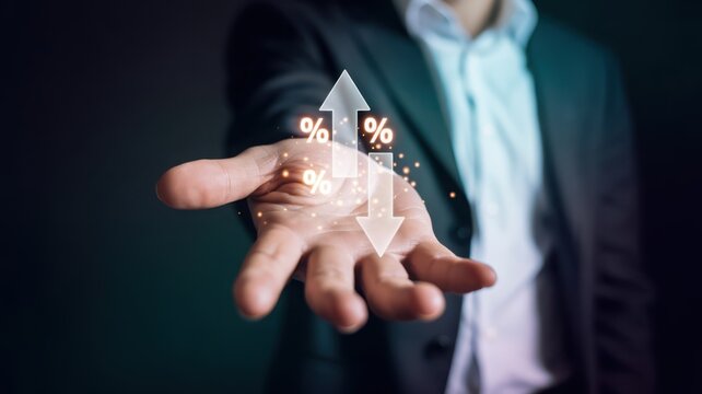 Businessman holding percentage icons with up and down arrows, financial interest rate and market trend concept.