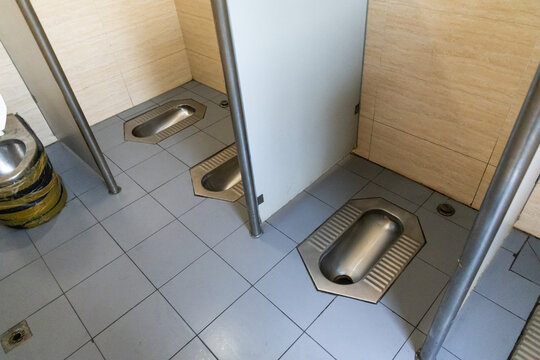 Public toilet in Beijing Hutong in cubicle but without doors. No privacy.