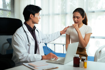 Fototapeta premium Doctor comforting asian patient having cough in clinic