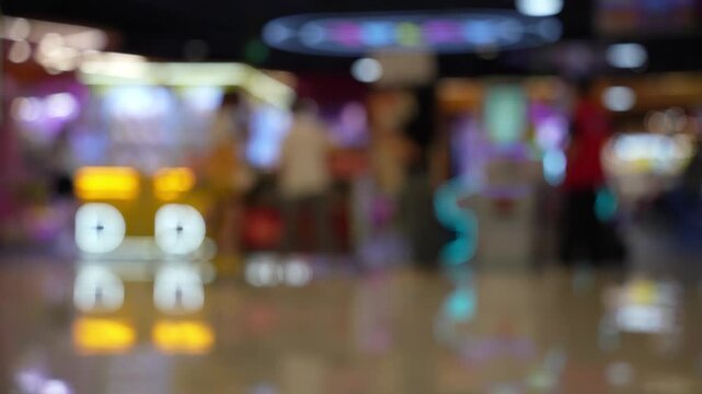 Blurred view of amusement arcade game center, toy crane game vending machine
