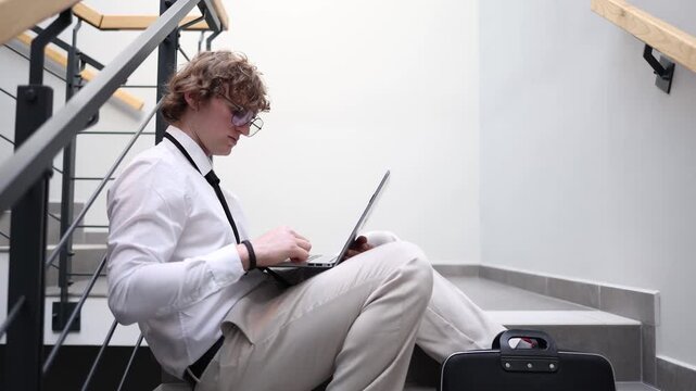 Ambitious young programmer works on laptop dreaming about big future career growth innovation success and breakthrough ideas focused mindset modern tech lifestyle determination