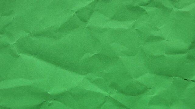 Seamless loop of green wrinkled paper texture. Vibrant stop-motion animation for creative projects, eco-friendly themes, and video backdrops.