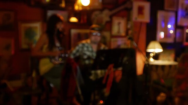 Blurred defocused live music jazz band performance inside cozy vintage bar with warm golden red bokeh ambiance nightlife