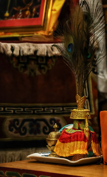 Close up of a  beautiful Buddhist Bhumpa pot or ritual water vase used in sacred ceremonies with peacock feathers.Buddhism spiritual and travel background image.Prayer objects used by buddhist monks.