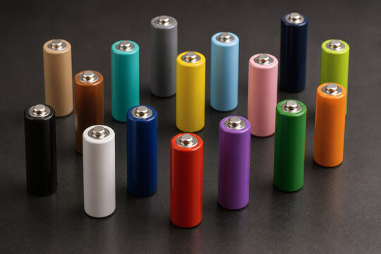 Colorful generic batteries collection on dark background, energy and technology concept