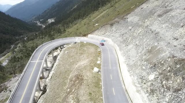 Aerial view of car driving on mountain.