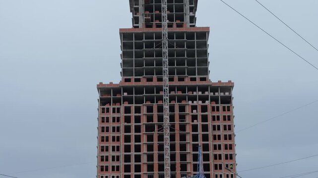 High rise building under construction with crane